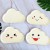 8 white cloud disks with yellow smiling faces 