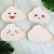 8 white cloud disks with white pink smiling faces 